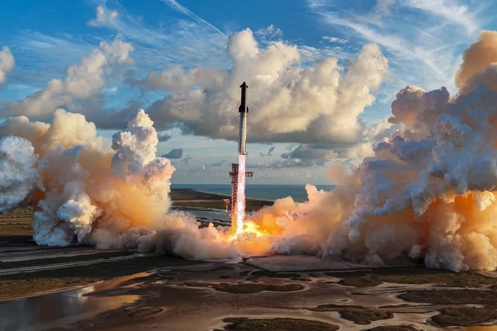 Rocket launch beneath a bright cloud-filled sky